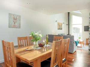 a dining room with a wooden table and chairs at Wonkey Donkey Cottage in Seaton