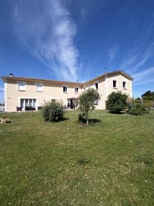 a large house with a large grassy field in front of it at Le Clos de Bourdeilles Studio in Brantome en Perigord +6 photos
