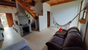 a living room with a couch and a fireplace at Chalé Solar SA in Bocaina de Minas