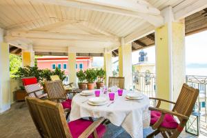 a table with a white table cloth on a patio at Appartamento Ronco in Ghiffa
