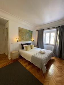 a bedroom with a large bed and a window at Suites Vintage in Lisbon