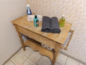 a wooden table with towels and soap on it at Chez les Petits in Rochefort +7 photos
