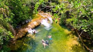 a group of people swimming in a river at Hotel Cabanas in Bonito