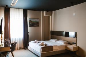 Llit o llits en una habitació de Garni Uni Elita Lux Hotel