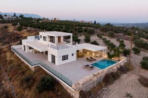 an aerial view of a house with a swimming pool at Benessere in Kamilari