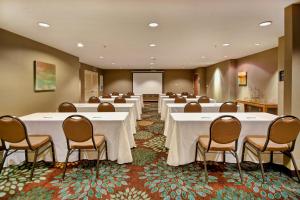 a conference room with tables and chairs and a screen at Staybridge Suites Madison - East by IHG in Madison +36 photos