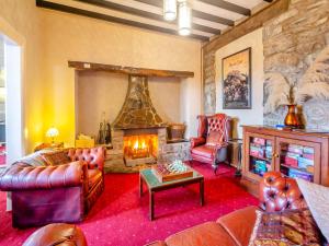 a living room with a couch and a fireplace at Noddfa in Harlech