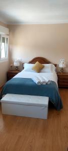 a bedroom with a large bed with two pillows at Las Tres Mimosas in San Vicente de la Barquera