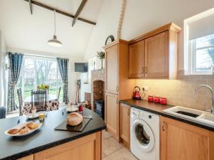 a kitchen with a washer and dryer on a counter at One Chainbridge Barns in Skegness +17 photos