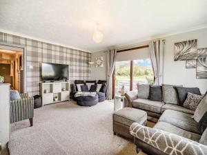 a living room with a couch and a tv at Highview in Brodick
