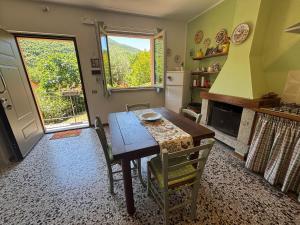 a kitchen with a wooden table and a table and chairs at Voce del Casentino in Castel San Niccolò