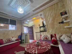 a living room with a bed and a couch at beautiful adresse " appartement vaste de luxe" in Agadir