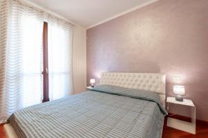 a bedroom with a bed and a large window at AnnaLand in Padenghe sul Garda