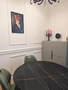 a dining room with a table and two chairs at VENI VEDI VICHY climatisé, 50m2 coeur de ville in Vichy