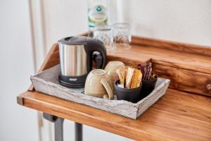 a wooden shelf with a coffee maker and cups on it at Rochter Landhotel in Zeltingen-Rachtig