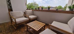 a balcony with two chairs and a table at 3BR - Bremerhaven Apartment in Bremerhaven