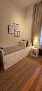 a bedroom with a large white bed with a window at 3BR - Bremerhaven Apartment in Bremerhaven