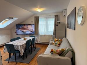 a living room with a couch and a table with chairs at Emun Grigo Lofthouse in Cluj-Napoca