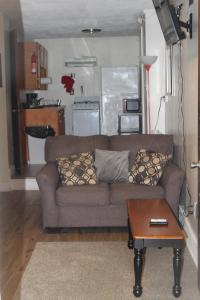 a living room with a couch and a table at HISTORIC HILL APT2 (Downstairs) in Tuskegee