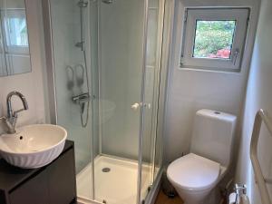 ラナースにあるIndbydende bed & breakfast med dejlig gårdhaveのシャワー、トイレ、洗面台を備えたバスルーム