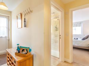 a bathroom with a walk in shower next to a bedroom at Stella's Retreat in Loddon +8 photos