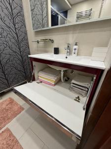 a bathroom with a sink and a mirror at Comfortable family apartments in Przno in Pržno