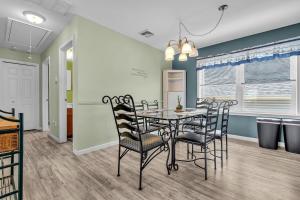 a dining room with a table and chairs at Game Room, Kayaks, Steps to the Ocean! in Ocean Gate