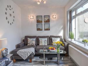 a living room with a couch and a table at La Casita in Herne Bay