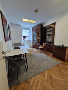 a living room with a table and a couch at Ritual Studio City Center in Ljubljana
