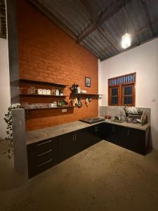 a kitchen with a sink and a counter top at Mahiyanganaya Holiday Resort in Mahiyangana
