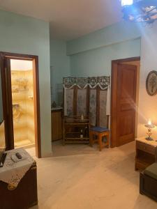 a living room with a door and a room with a table at Hliannas house in EFL