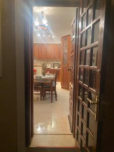 an open door to a kitchen with a dining room table at Hliannas house in EFL