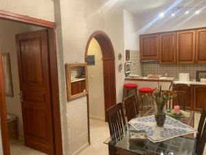 a kitchen with a table and a dining room at Hliannas house in EFL