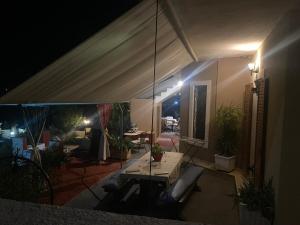 a living room with a table and a patio at night at Hliannas house in EFL
