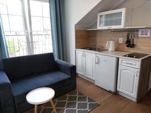 Kuchyňa alebo kuchynka v ubytovaní Słoneczne Apartamenty w Poddąbiu + 6 fotografií