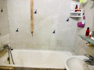 a bathroom with a bath tub and a sink at Cyrnos in Fez