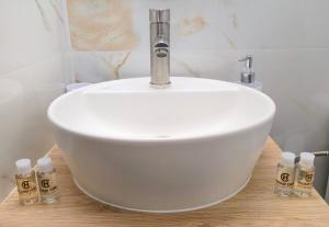 a white sink sitting on a wooden counter in a bathroom at Ourania's and Lena's House in Petra