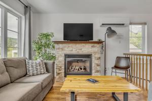 a living room with a couch and a fireplace at Initial - Jumeau 35 - MSA in Saint-Férréol-les-Neiges