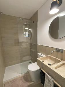a bathroom with a shower and a toilet and a sink at That Place For U - Blue House in Costa da Caparica