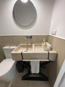 a bathroom with a sink and a mirror and a toilet at That Place For U - Blue House in Costa da Caparica +18 photos