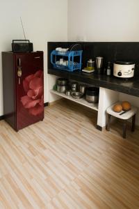 a kitchen with a refrigerator and a wooden floor at galle villa in Galle
