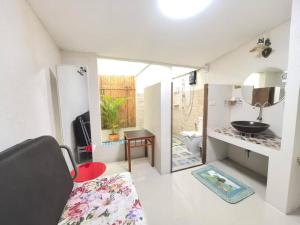 a bathroom with a sink and a toilet in a room at Koko Palm Inn in Chiang Mai