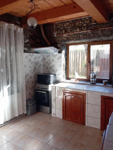a small kitchen with a stove and a window at Casa David Andrei Dubova in Dubova