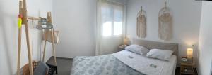 a bedroom with a bed with white sheets and pillows at North eye in Apollon