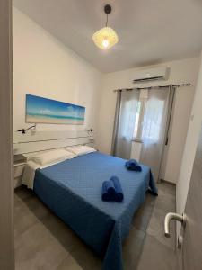 Ένα ή περισσότερα κρεβάτια σε δωμάτιο στο Casa FOXI MANNA