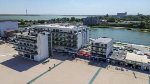an aerial view of a building next to a body of water at Miraky Beach in Văleni