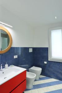 a bathroom with a sink and a toilet and a mirror at A' Terrazza in Santa Flavia