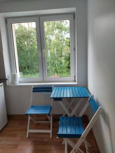 a room with a table and two chairs and a window at Wypoczynkowo in Stegna +29 photos