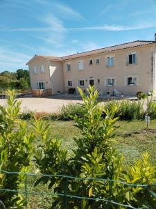 a large building in the middle of a yard at Le Clos de Bourdeilles chambre 1 avec wifi in Brantome en Perigord +8 photos