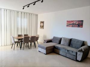 a living room with a couch and a table at Old Beach Apartments 2 in Vlorë
